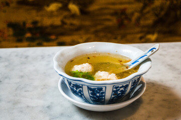 An appetiser of Crab and Chicken Meatballs  in chicken consomme