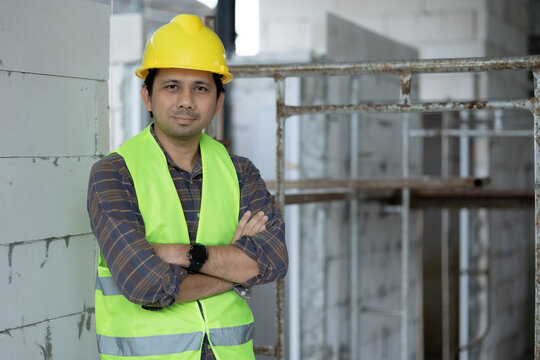 portrait of asian construction worker looking at camera
