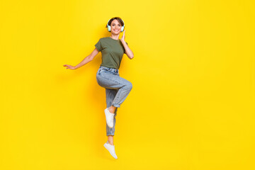 Fototapeta na wymiar Full length photo of cheerful lady dressed stylish outfit rejoice discount device shop jump empty space isolated on yellow color background