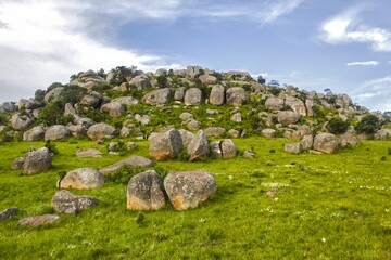 Green hill with rocks against the background of blue sky. Eswatini, Southern Africa.
