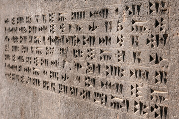 Cuneiform inscription on Susi temple in Erebuni fortress (since 782 B.C.) on sunny morning. Yerevan, Armenia.