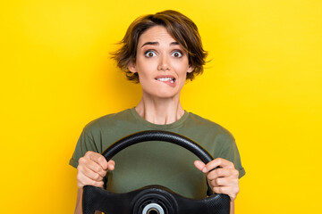 Portrait of stressed worried woman bob hairdo khaki t-shirt hold steering wheel get in accident isolated on yellow color background