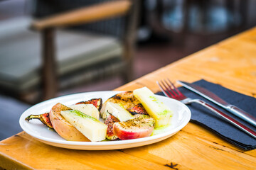 Fig & Peach appetiser of Grilled peach, grilled fig, taleggio cheese, yuzu dressing