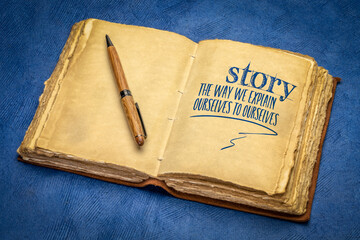 story - the way we explain ourselves to ourselves, handwriting in a retro journal with a cup of...