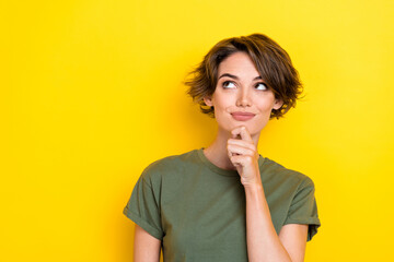Portrait of nice cute woman with bob hairdo dressed khaki t-shirt look empty space finger on chin...