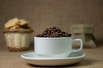 White cup full of coffee beans. natural coffee drink