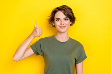 Portrait of satisfied gorgeous pretty girl bob hairstyle wear khaki t-shirt showing thumb up good...