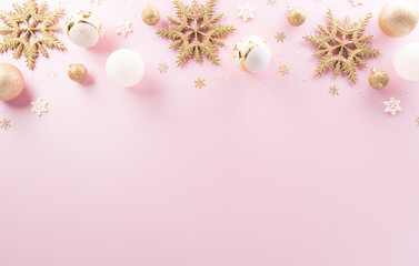 Christmas and new year background concept. Top view of Christmas ball, star and snowflake on pastel pink background.