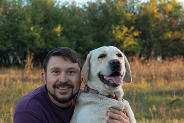 Handsome young man with his dog. canadian labrador