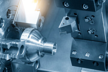 The CNC lathe machine thread cutting at the end of metal stud parts.