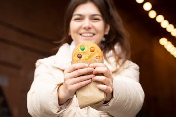 Close-up, a beautiful gingerbread in the hands of a woman.