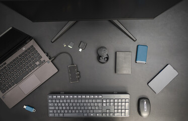 Work station of program developer. Top view on black background. Technological concept