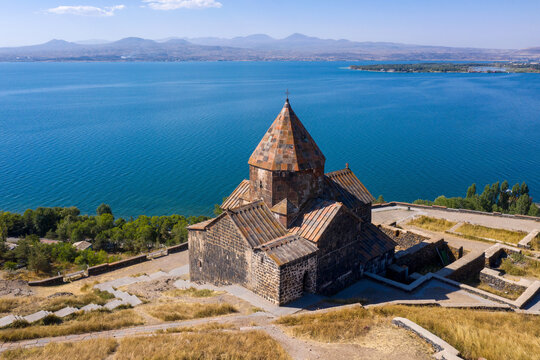 Aerial view of Surp Arakelots (Holy Apostles) church of Sevanavank monastery and Sevan lake on sunny day, Armenia.