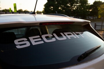 Side view of security patrol car parked outdoors - obrazy, fototapety, plakaty