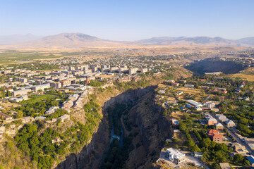 Fototapeta na wymiar Aerial view of Razdan canyon, Arzni village (right) and Nor Geghi town (left) on sunny summer day. Kotayk Province, Armenia.