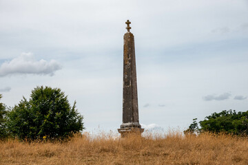 old stone obelisk in the English countryside