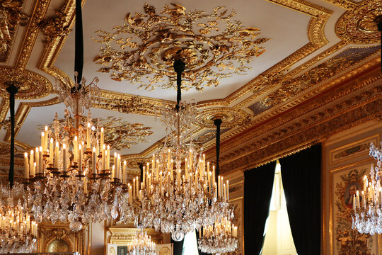 Paris, France - 08.08.2022: Magnificent chandeliers and gilded stucco in the interiors of the Hotel de la Marine