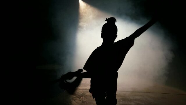 silhouette of junior samurai girl with katana, attacking moving to camera in darkness, danger