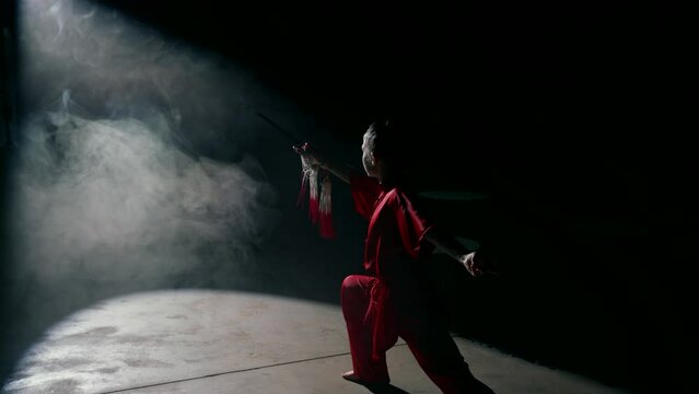 silhouette of young japanese warrior with katana in darkness, pose of attacking, girl in red kimono