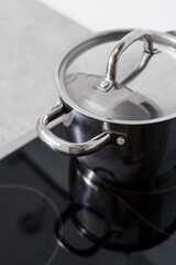 closeup of cooking pot on electric hob at kitchen