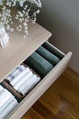 Fototapeta na wymiar storage clean towels in dresser in living room