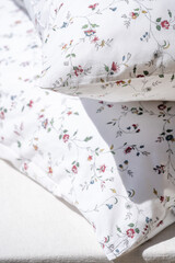 closeup of pillows in cotton case with flower pattern at home