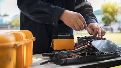 Engineer or technician are install fiber optic cable lines for maintenance.