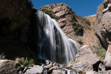 Long exposure shot of Trchkan waterfall on sunny summer day. Lori Province, Armenia.