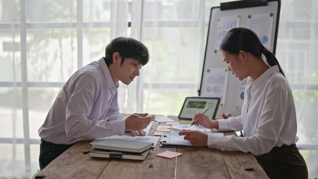 Business people are working on their business. Discussed about paperwork that shows chat and graft of accounting statistics, number of cost.