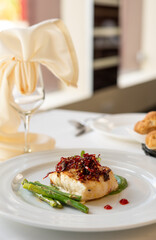 Beautiful served fish on plate. With natural vegetables, green beans. Shabbat food.