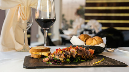beef with vegetables, sauce, and bread. mexican dish arrachera. black background