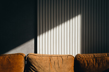 A ray of sun on a textured wall in a room.