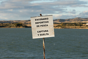 A sign at the reservoir San Bartolome water reserve, indicating sport fishing, catch and release, Aragon, Spain