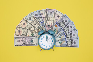 Alarm clock and money on a colored background, minimalism.