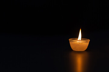 Candle lighting. Shallow depth of field. Numerous Christmas candles light up at night. abstract...