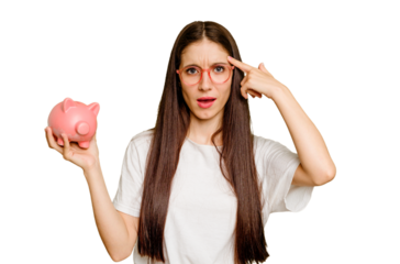Young caucasian woman holding a piggy bank isolated showing a disappointment gesture with forefinger.