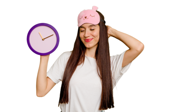 Young caucasian woman wearing pajama and holding a clock touching back of head, thinking and making a choice.