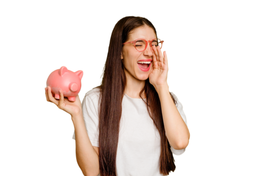 Young caucasian woman holding a piggy bank isolated shouting and holding palm near opened mouth.