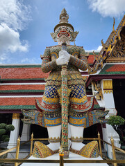 The giant guarding the temple's door at Wat Phra Kaew 11th name, cakravarti, white body with four heads crowned at the top of a rooster's tail, holding a mace, Bangkok, Thailand.