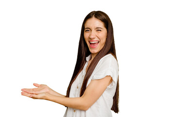 Young caucasian long hair woman isolated holding a copy space on a palm.