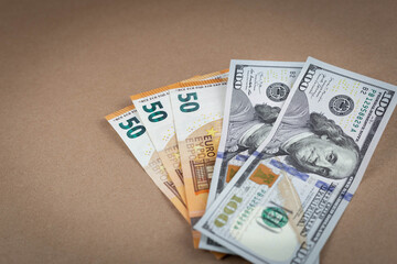 Paper money banknotes dollars and euros on a brown background with a vintage paper texture. Close up. Copy Space. Grunge