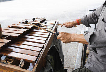 Hands of anonymous street musician playing xylophone with ball mallets in Guadalajara city, Mexico
