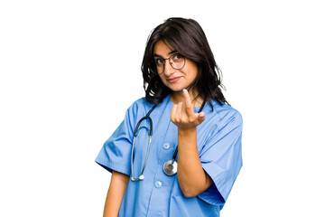 Young nurse Indian woman isolated pointing with finger at you as if inviting come closer.