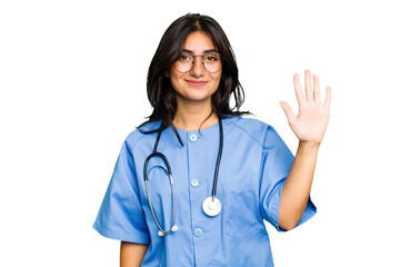 Young nurse Indian woman isolated smiling cheerful showing number five with fingers.