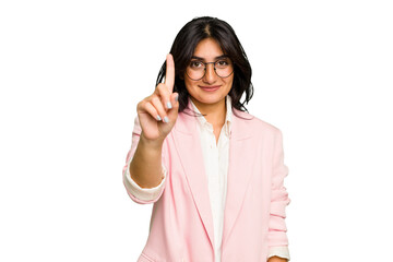 Young Indian business woman wearing a pink suit isolated showing number one with finger.