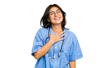 Young nurse Indian woman isolated laughs out loudly keeping hand on chest.
