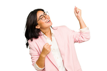 Young Indian business woman wearing a pink suit isolated raising fist after a victory, winner...