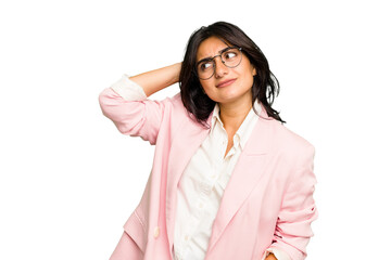 Young Indian business woman wearing a pink suit isolated touching back of head, thinking and making...