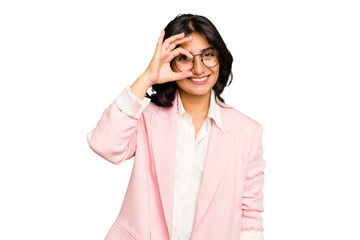 Young Indian business woman wearing a pink suit isolated excited keeping ok gesture on eye.