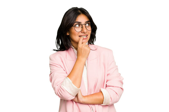 Young Indian Business Woman Wearing A Pink Suit Isolated Relaxed Thinking About Something Looking At A Copy Space.